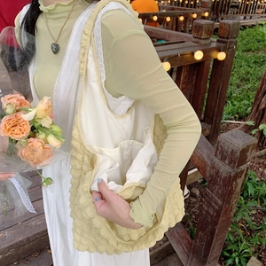Close-up of yellow bubble textured tote bag showing white inner lining and pocket