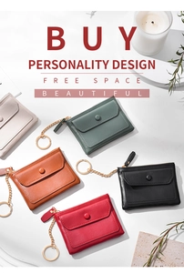 Flat lay of colorful PU leather coin purses with metal keychains on marble background