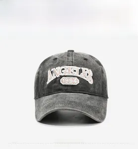 Detailed view of vintage washed grey cotton baseball cap with ANGELES 1994 embroidery