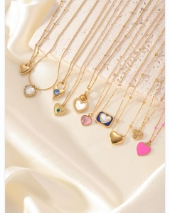 Macro view of heart pendants in 18K gold plating with colorful natural stones and enamel