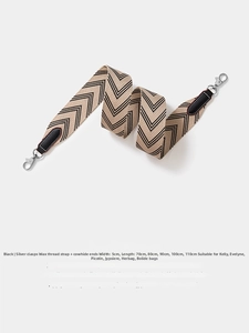 Close-up of 5cm wide beige and black herringbone woven strap with leather ends
