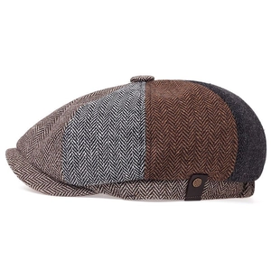 Detail of herringbone wool fabric and side leather buckle on vintage newsboy cap