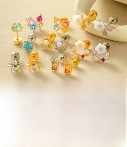 Macro detail of stainless steel earrings featuring colorful butterfly and heart zirconia studs