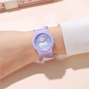 Close-up of kids unicorn watch with purple silicone strap and colorful rainbow details