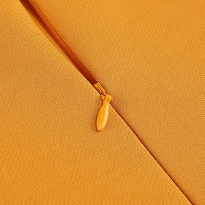 Macro view of orange invisible zipper on solid color tube dress with fine plain texture