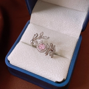 Detail of leaf-shaped silver ring with pink zircon gemstone in a blue velvet box