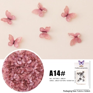 Macro detail of 3D pink butterfly nail art charms with iridescent glitter on beige background