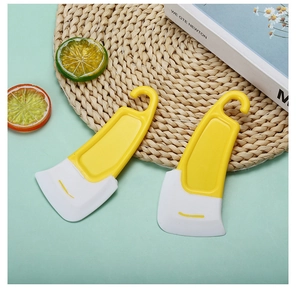 Detail of two yellow silicone scrapers for cleaning kitchen oil stains on green background