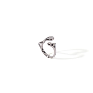 Detailed view of silver minimalist open ring with curved organic lines and polished finish