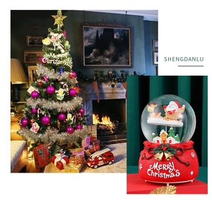 Detail of Christmas snow globe featuring Santa and reindeer on a festive red base