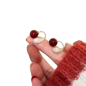 Elegant gold plated earrings with dark red drop pearls and sparkling zircon accents