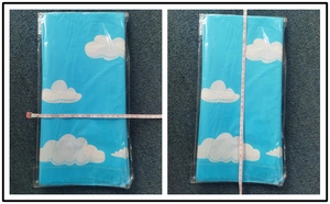 Blue sky cloud party tablecloth dimensions measured with a measuring tape closeup