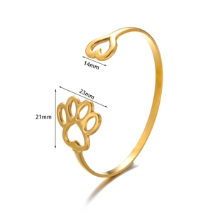 Detail of gold open bangle with 14mm heart and 23mm cutout paw charm dimensions