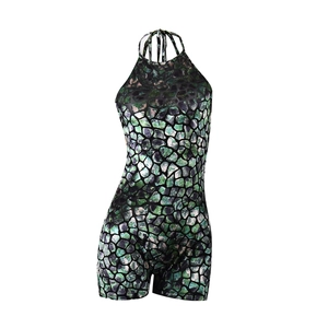 Detail of green and black pebble-patterned halter jumpsuit with metallic finish texture