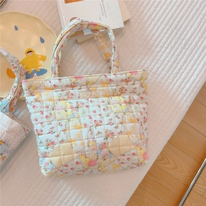Close-up of floral quilted cotton tote bag with a simple wish brand label detail