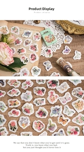 Macro detail of vintage floral and butterfly stickers with decorative scrapbooking props