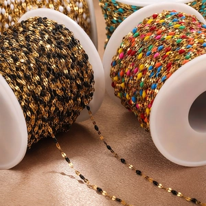 Gold stainless steel bulk chains with colorful enamel lips on white plastic spools