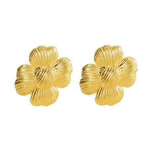 Macro detail of gold-finish four-petal flower earrings with textured metallic surface