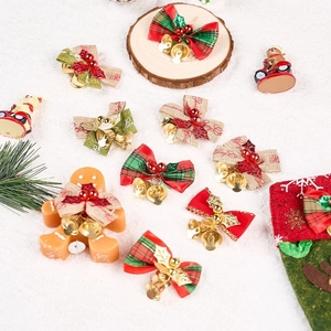 Festive Christmas bows with golden bells and red berries displayed on white snow
