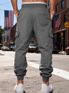 Back view of dark grey cargo joggers with fleece lining and multiple utility pockets