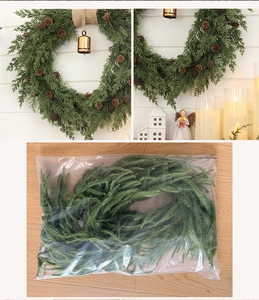 Detailed view of artificial Christmas wreath with pine cones and small golden bells