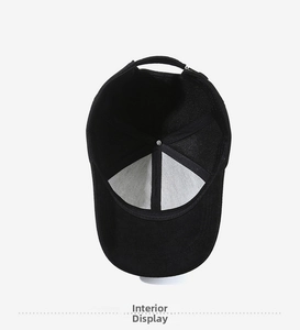 Interior view of black cotton baseball cap showing reinforced stitching and adjustable strap