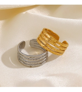 Detail view of 18K gold and silver plated hammer textured multi-layer stacked rings