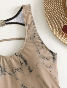 Close-up of marble print bikini top with metal buckle and thin straps for summer beach