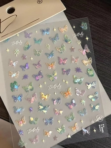 Detail of holographic butterfly nail stickers with aurora effect on TO-2962 packaging