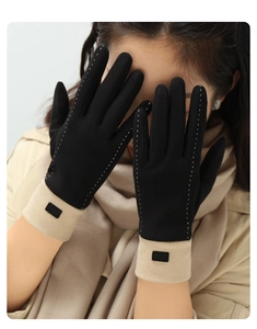 Detail of warm black and beige touchscreen gloves with decorative white stitching
