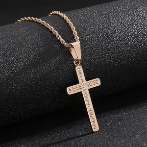 Close-up of sparkling crystal-encrusted rose gold cross pendant on a matching twisted chain