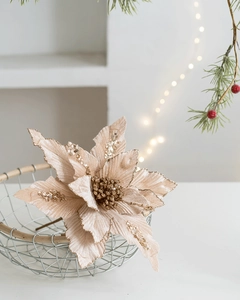 Dettaglio di stella di Natale in velluto champagne con petali glitterati in cestino