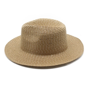 Macro shot of light brown straw hat weave texture with subtle shimmering sequins