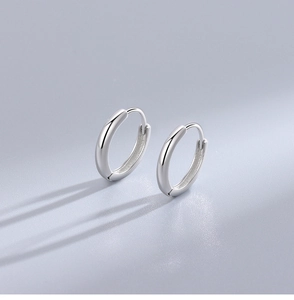 Detailed view of polished S925 sterling silver hoop earrings with minimalist high-shine finish