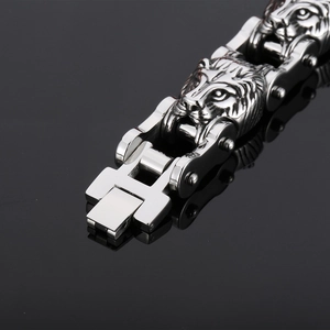 Detailed close-up of a masculine silver lion head link bracelet with a secure H-lock clasp