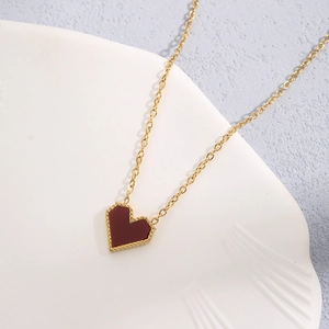 Elegant gold-plated heart pendant necklace with red enamel and textured gold beads