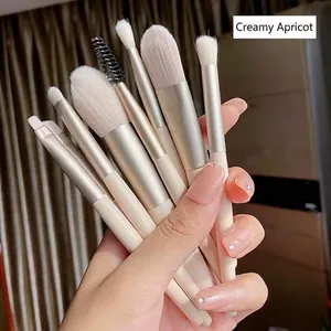 Set of 8 creamy apricot makeup brushes with soft white bristles for face and eye makeup