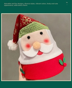 Detail of red Santa hat with golden snowflake patterns and plush white trim decor