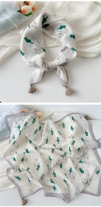 Close-up of linen cotton cat pattern scarf with fringe tassels and gray border detail