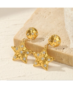 Detailed macro view of 14k gold plated star earrings with hammered texture and diamonds