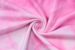 Detailed close-up of pink and white gradient tie-dye knit fabric with soft texture