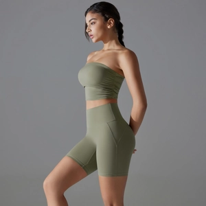 Detail of olive green high-waisted yoga shorts and ruched sports top set with matte fabric