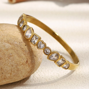 Detailed macro view of 18K gold plated bangle featuring multi-shape cubic zirconia stones