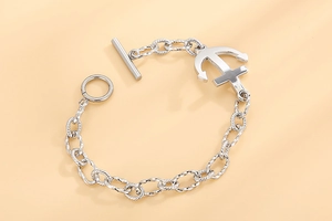 Macro detail of silver anchor charm and textured nautical chain with T-bar OT clasp