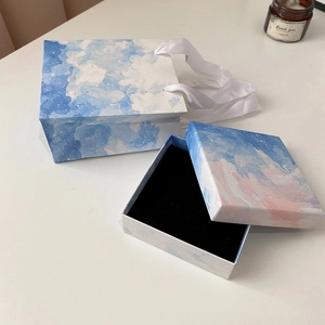 Close-up of blue and pink cloud pattern jewelry gift box set with matching ribbon handle bag