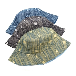 Distressed denim bucket hats in blue, grey and olive green colors for a retro street style