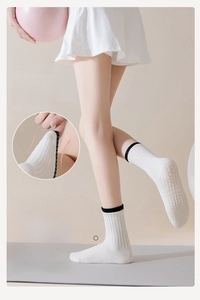Detail of yoga socks with non-slip silicone grip dots and high elastic knit cuff