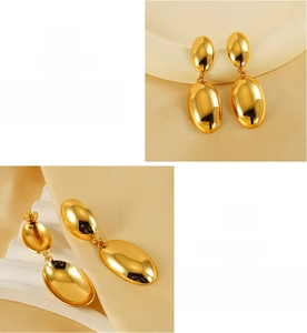 Detail of oval 18K gold plated stainless steel earrings with high polish mirror finish