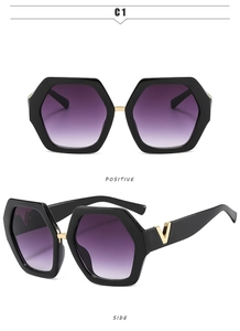 Detail of hexagonal black frames with purple gradient lenses and gold V-shaped metal temple