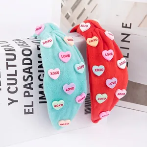 Pink and mint green plush knot headbands with heart-shaped XOXO and LOVE charms